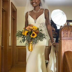 Elegant Cream Wedding Dress with Floral Bouquet